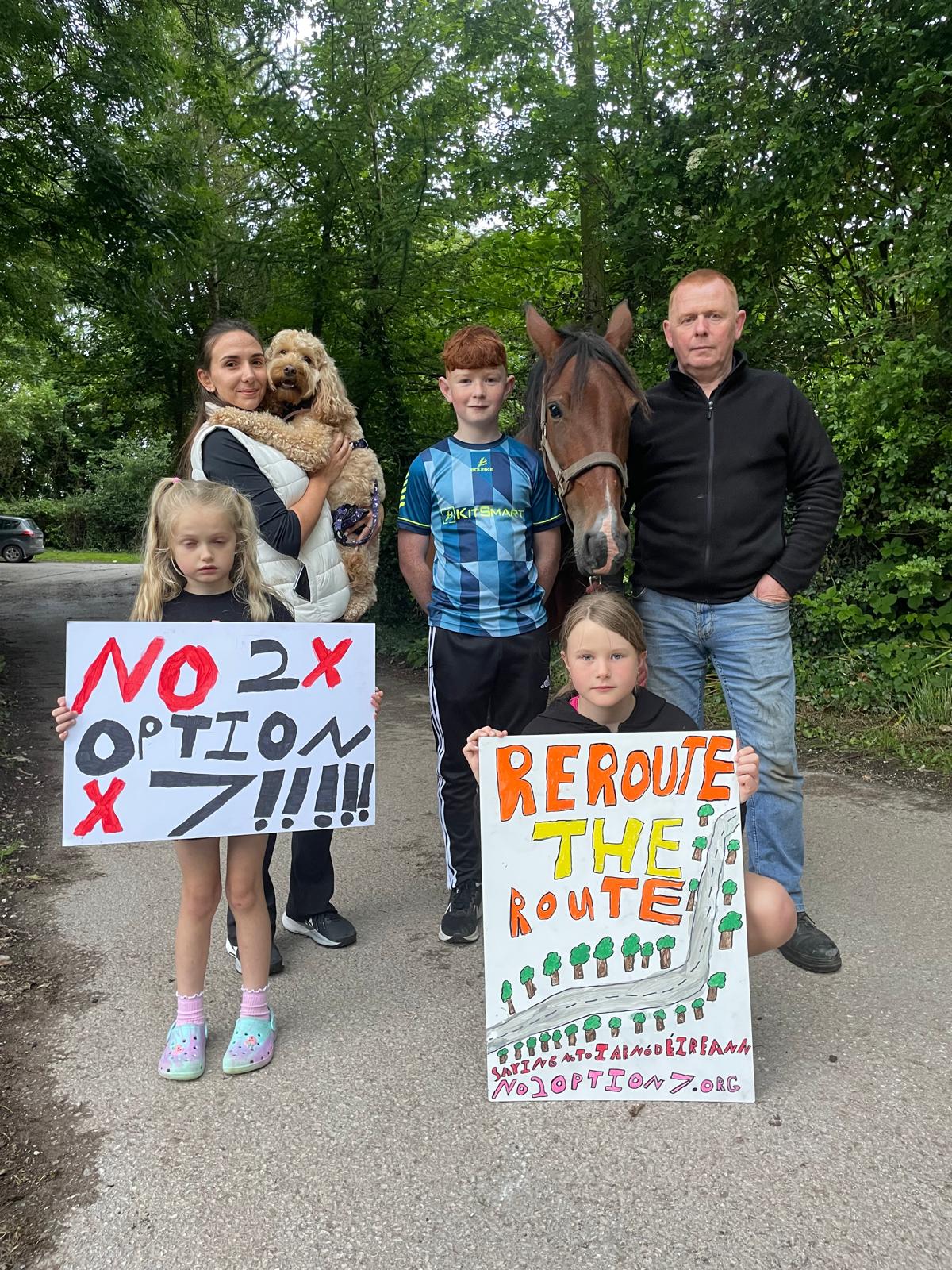 Family with horse holding protest signs